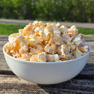 White bowl filled with apple crisp flavored popcorn.
