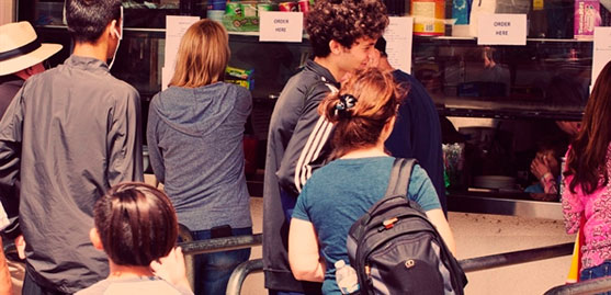 people in line at concession stands at colleges.