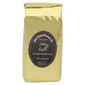 Gold metallic bag of coffee with black oval label which reads columbian supremo coffee in white lettering.