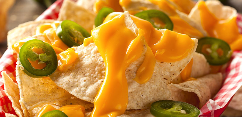 Basket of Nachos layered with warm cheese and jalapenos