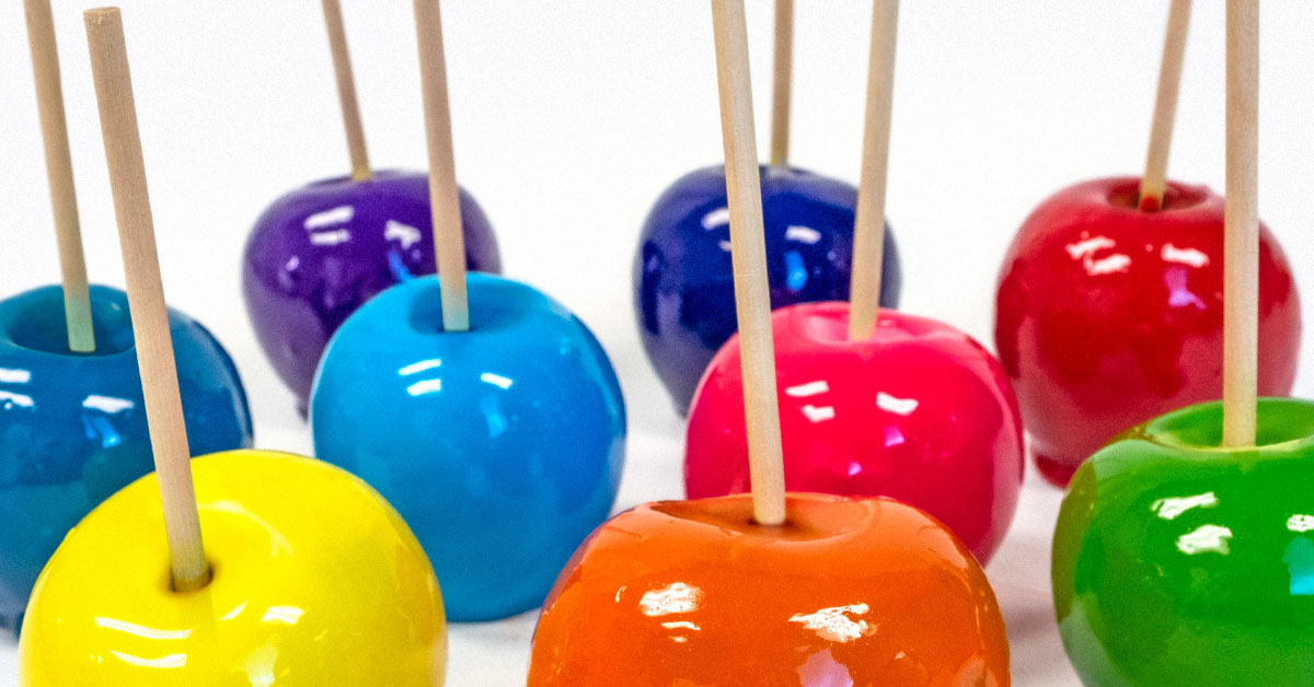 colorful candy apples of yellow, blue, greens, pink, purple, red with setter sticks