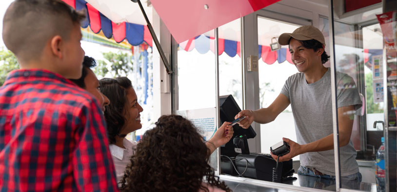 Concession stand worker accepting payment from a customer