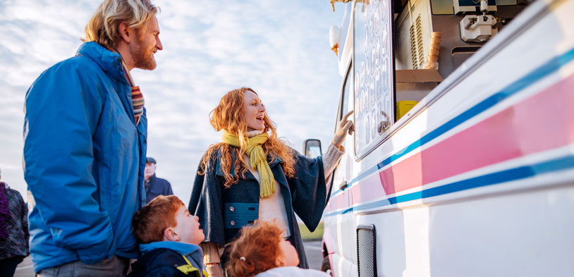 young family at food truck during winter