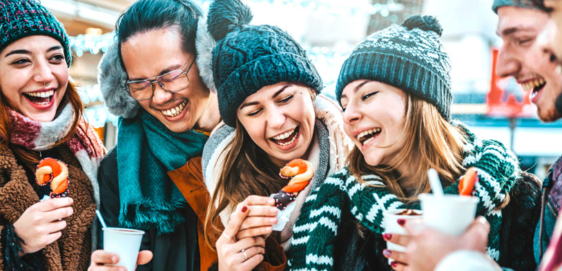 Friends outside drinking hot chocolate and eating snacks