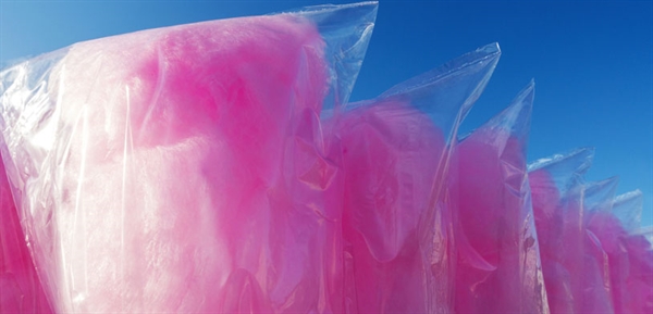 Pink cotton candy wrapped in bags against the blue sky