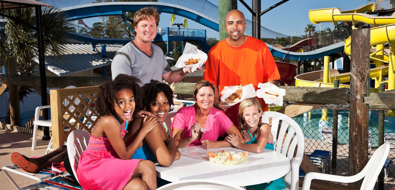 group at table at waterpark smiling