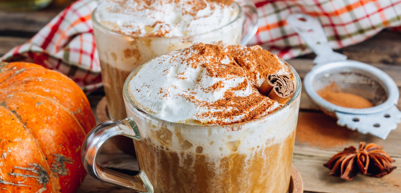 Cup of pumpkin spice latte with cinnamon on top