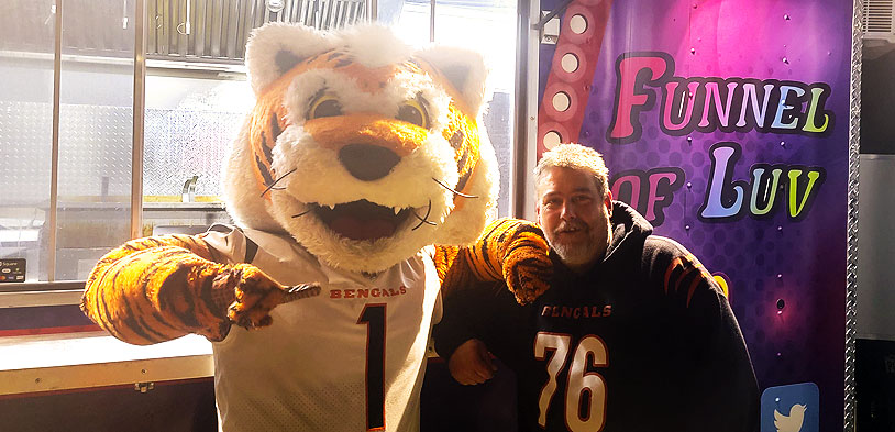 funnel pf luv owner standing with Cincinnati Benglas Mascot
