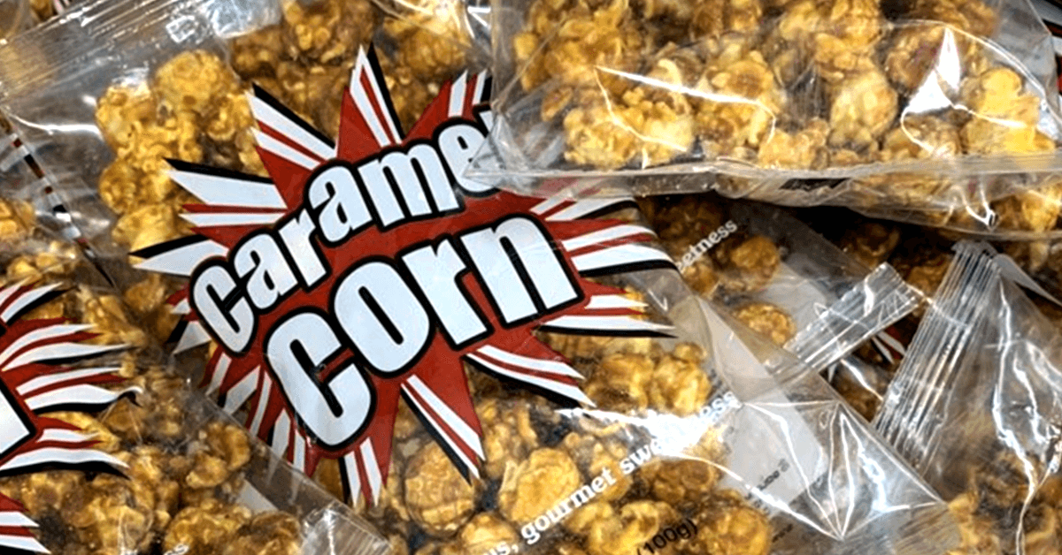 stack of clear bags with print, "Caramel Corn," containing caramel corn stack of clear bags with print, "Caramel Corn," containing caramel corn