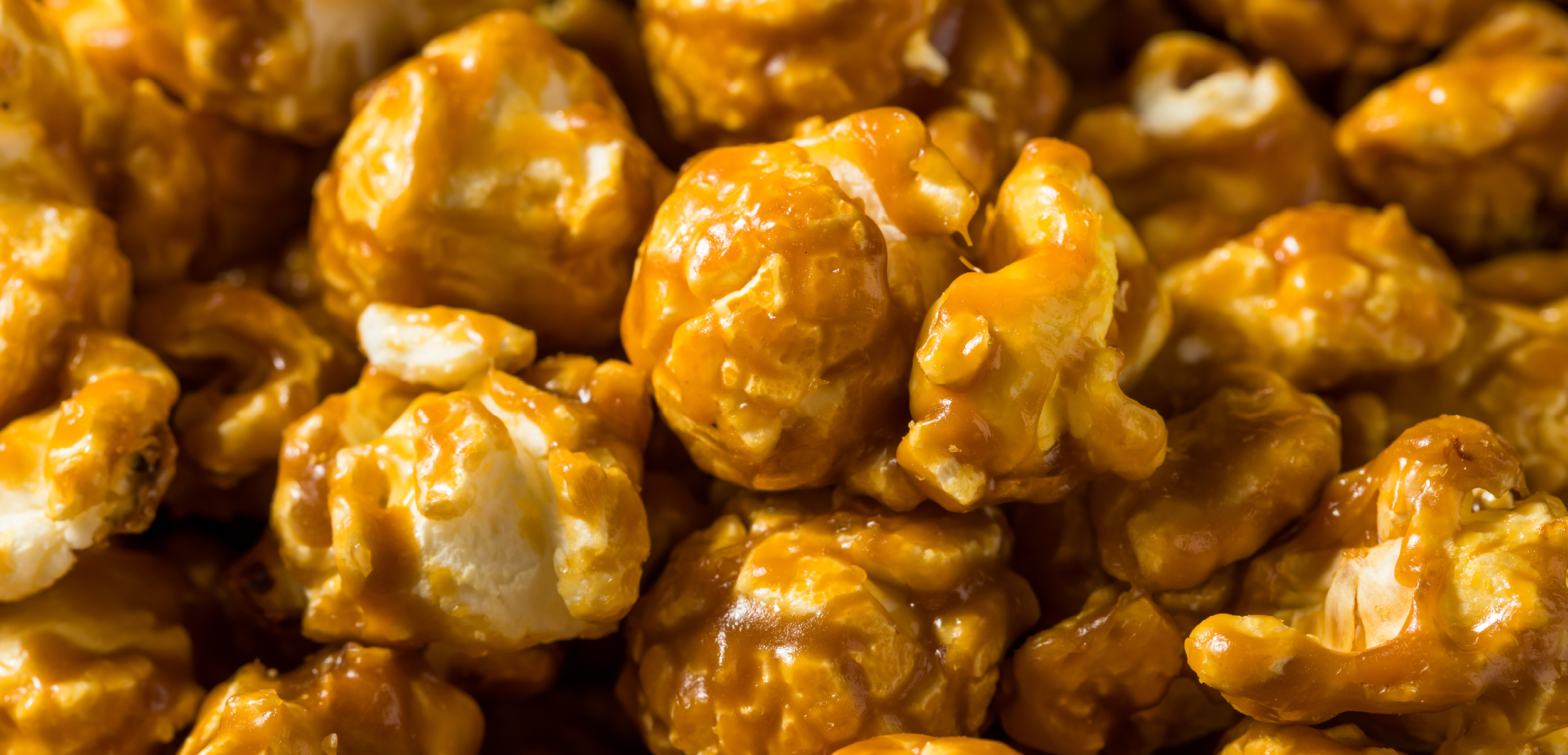 Close-up of glossy caramel-coated popcorn kernels Close-up of glossy caramel-coated popcorn kernels