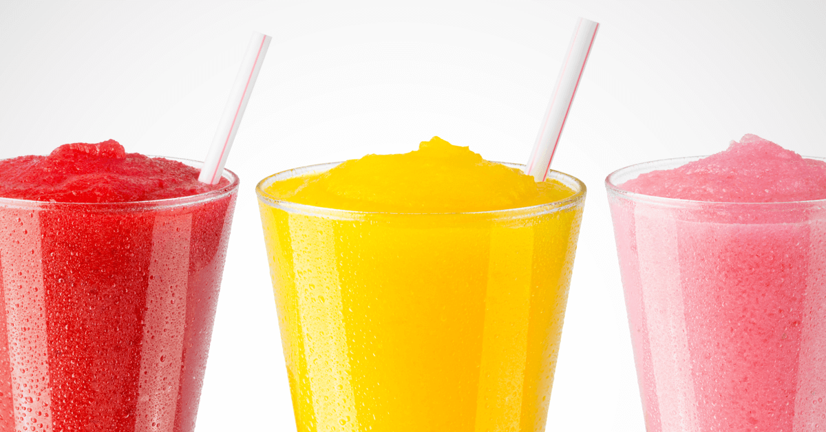 three Frusheez frozen slushy drinks of red, yellow, and pink color in glass cups three Frusheez frozen slushy drinks of red, yellow, and pink color in glass cups