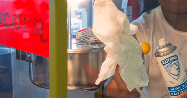 Person cleans the inside of their Gold Medal Popcorn Machine with cleaner