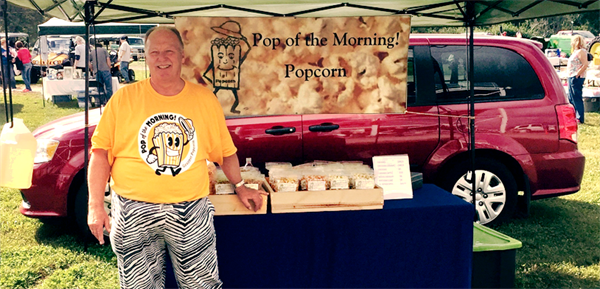 business owner stands in front of his small business products