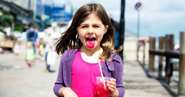 little girl on a pier with a frusheez in hand